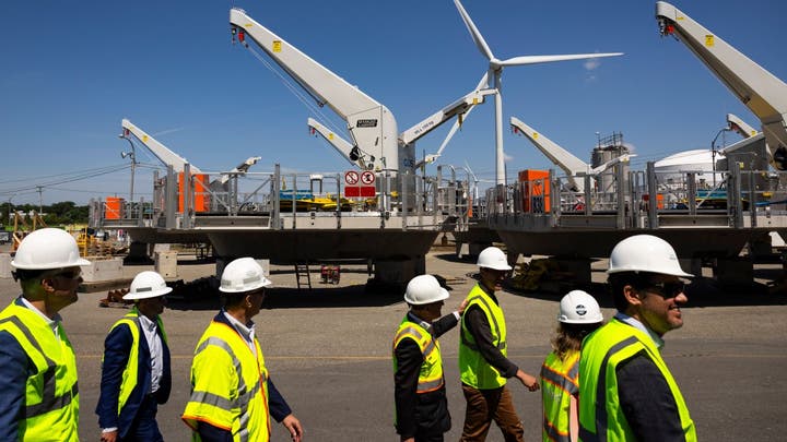 Wind‌ turbine farm, representing renewable energy projects ‍affected by the spending bill.