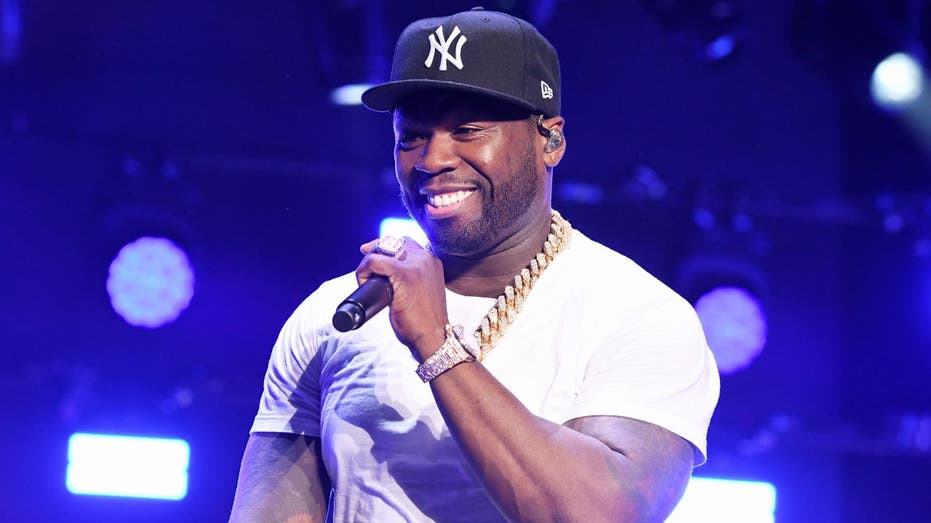 50 Cent holding microphone