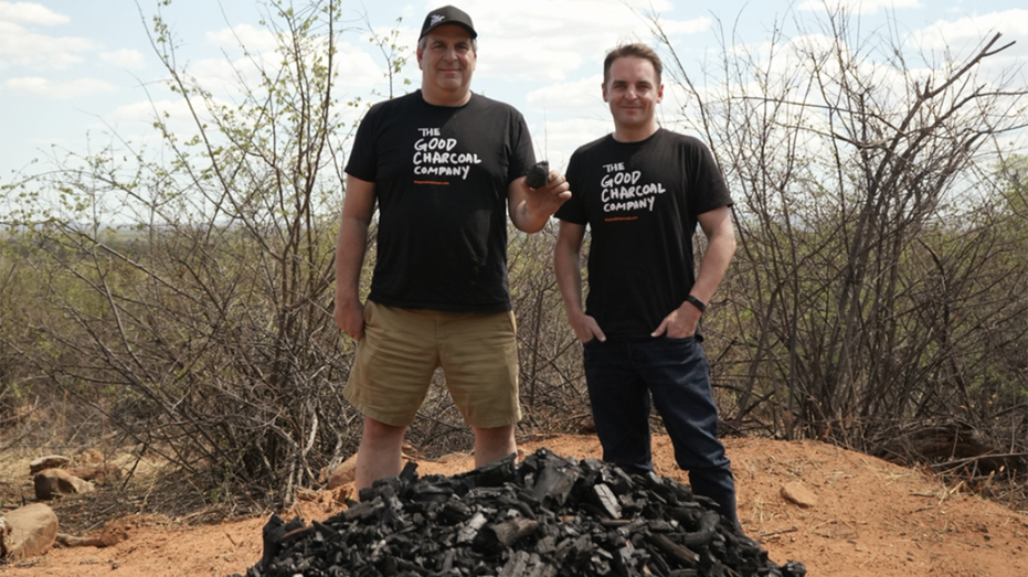 the good charcoal company founders in front of a mound of charcoal