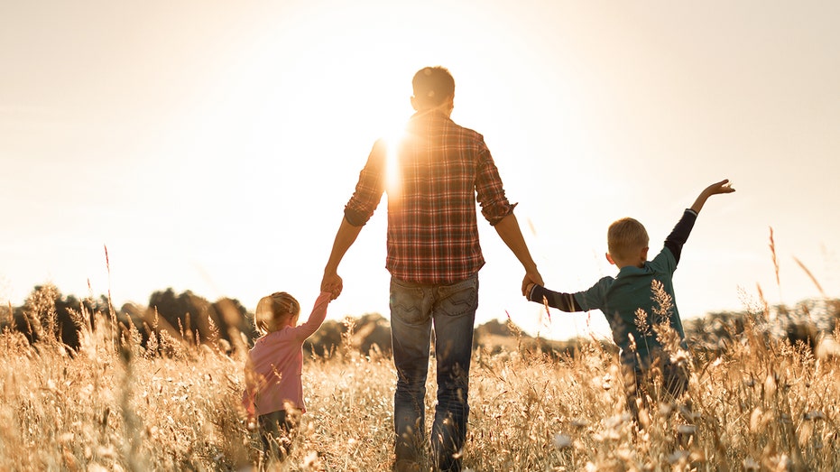 Father and kids in field