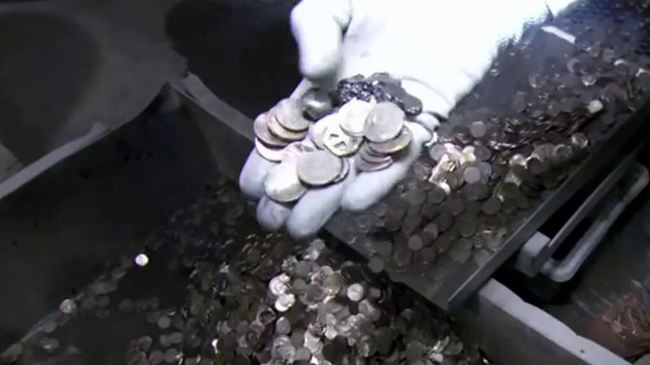 Jeff Flock holding coins