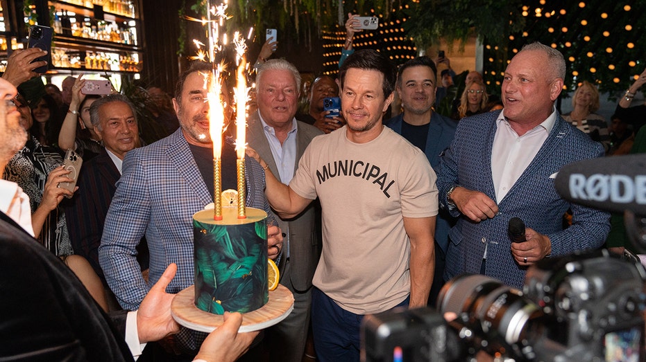 Mark Wahlberg celebrating birthday with cake and Dr. Paul Nassif