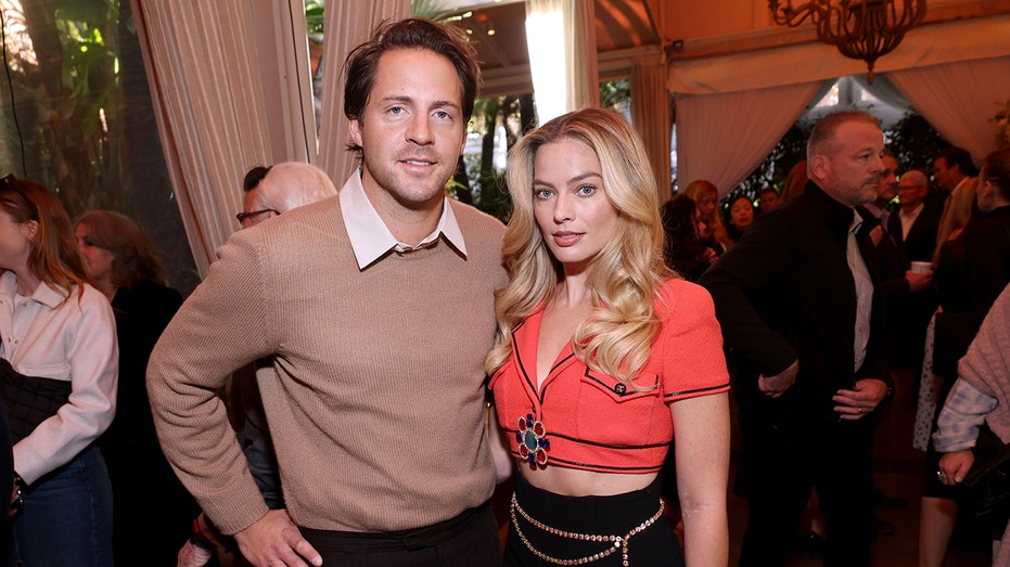 Thomas Ackerly and Margot Robbie posing together