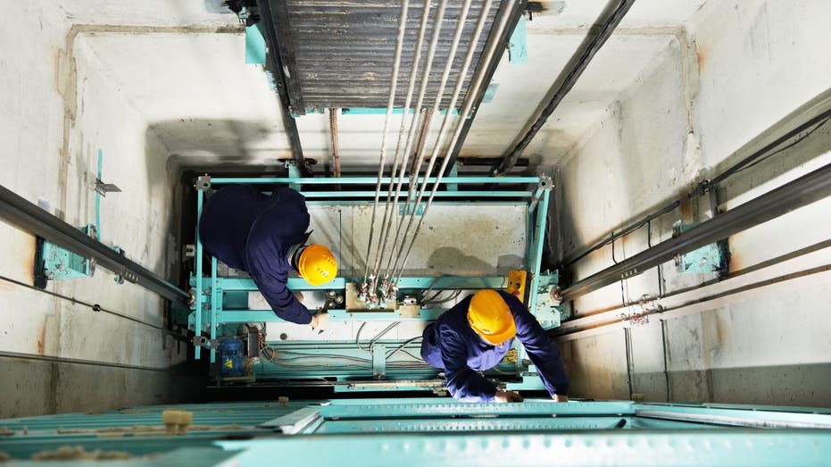 workers in an elevator shaft