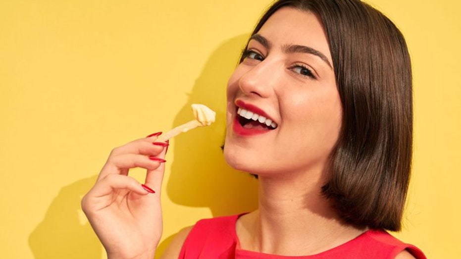 woman eating french fry and french fry yogurt