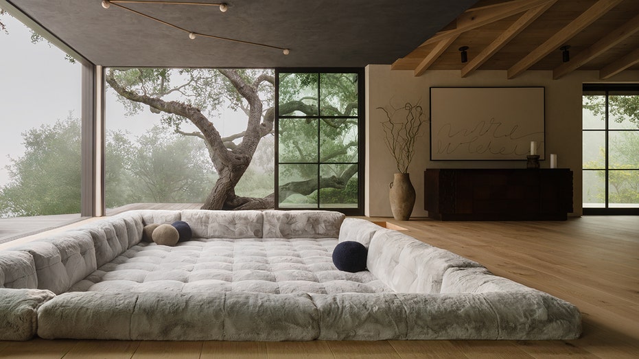 Large in-ground couch with a massive window and tree looking out