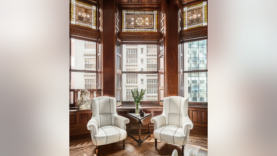 Two white chairs with glass transoms