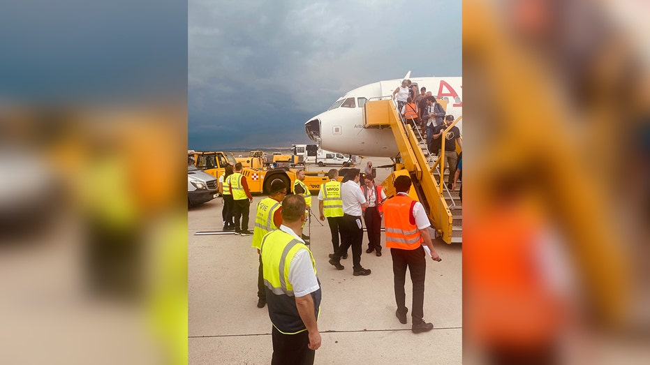 airport crew attends plane with missing cockpit nose