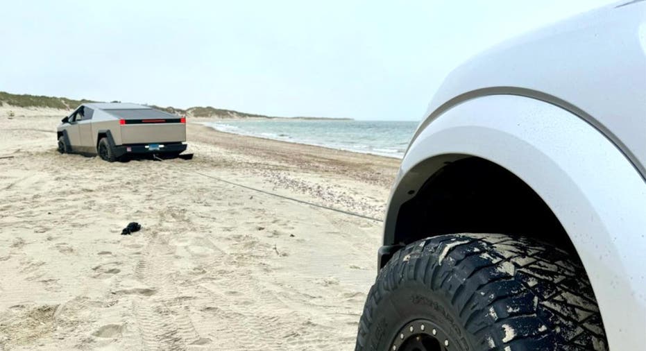 A Tesla Cybertruck is stuck in the sand