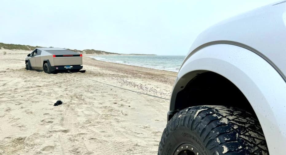 A Tesla Cybertruck is stuck in the sand