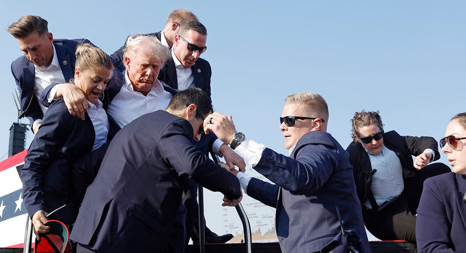 Donald Trump is rushed offstage during a rally