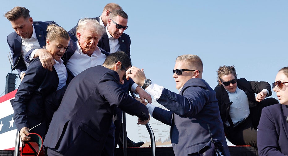 Donald Trump is rushed offstage during a rally