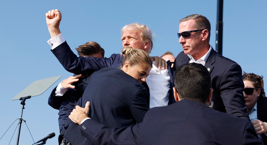 Donald Trump is rushed offstage during a rally