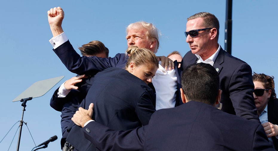 Donald Trump is rushed offstage during a rally
