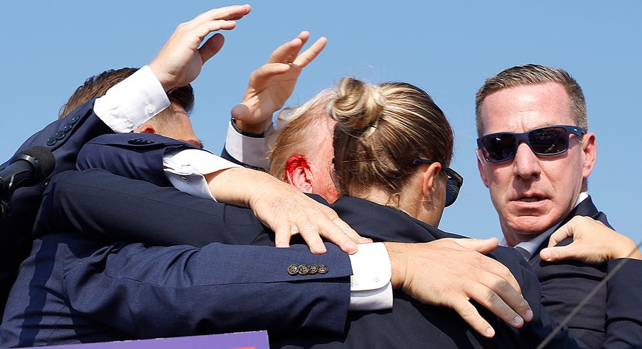 Donald Trump is rushed offstage during a rally
