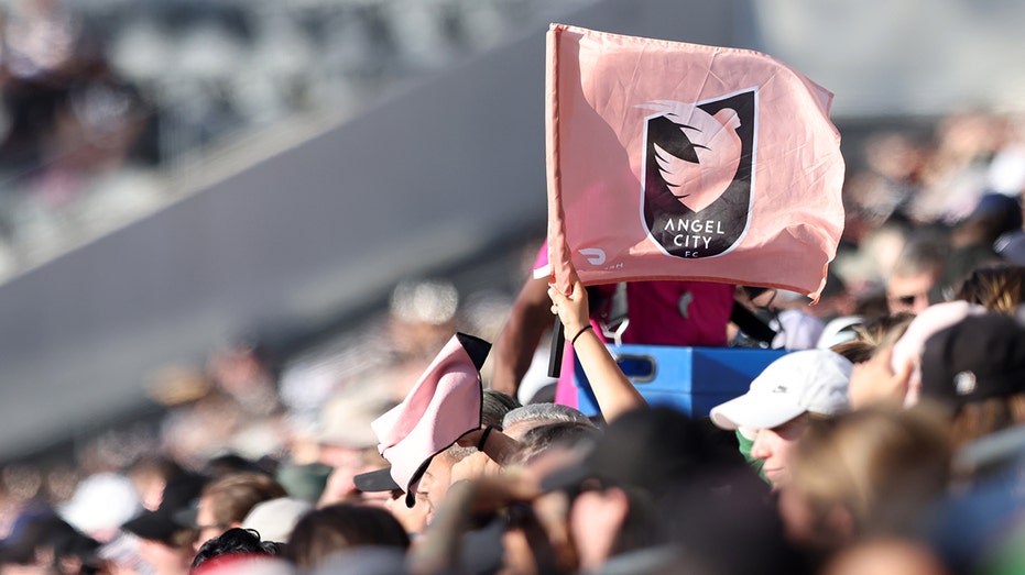 A fan waves an Angel City FC flag
