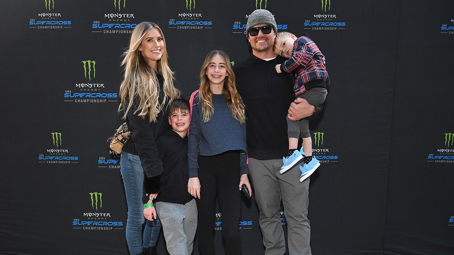 Christina Hall and Josh Hall posing with kids