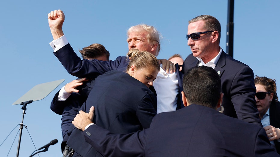 Donald Trump is rushed offstage during a rally