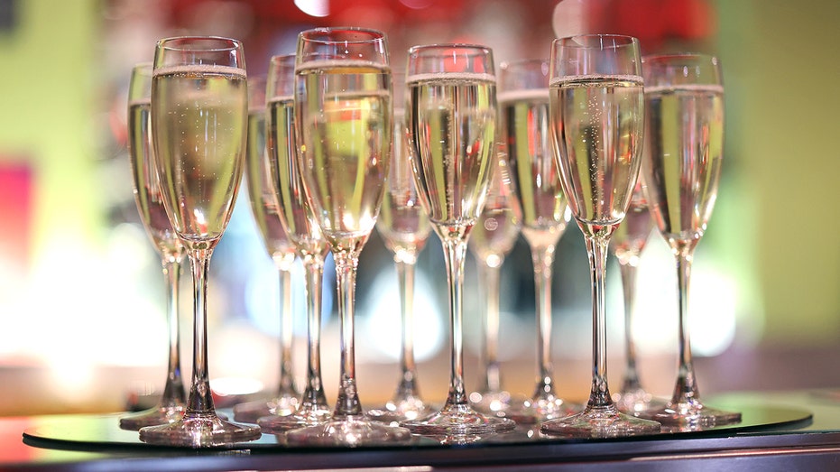 Champagne glasses filled with the sparkling wine on a tray