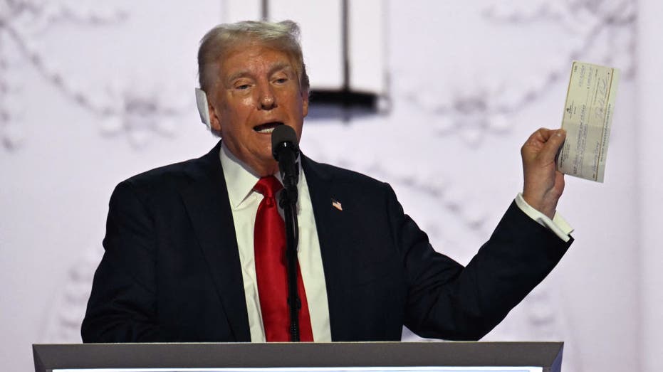 trump holding up check