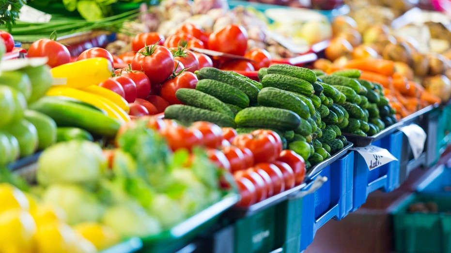 A table full of fresh vegetables at a grocery store.