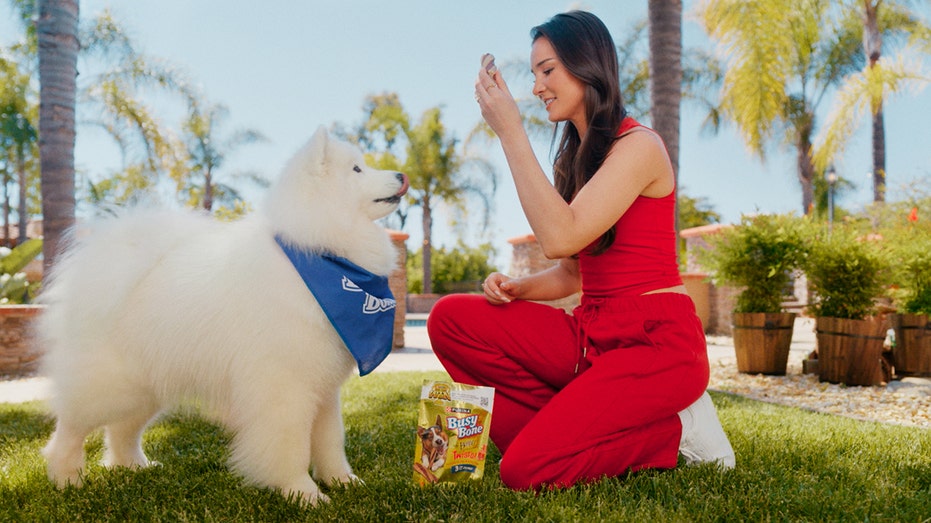 Kristin Juszczyk gives treat to dog