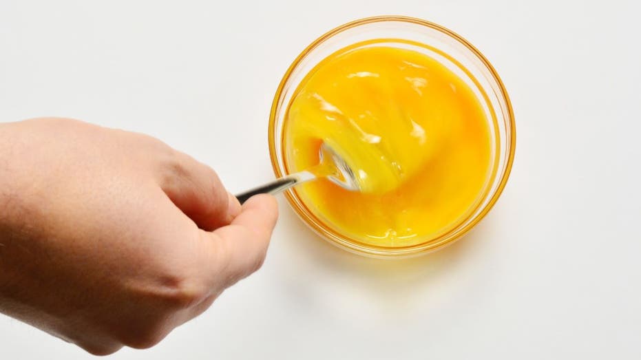 Person mixing eggs in bowl