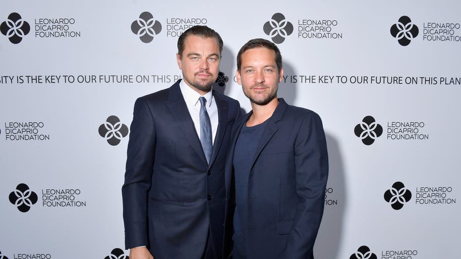 Leonardo DiCaprio and Tobey Maguire pose for photos at an event in Saint-Tropez