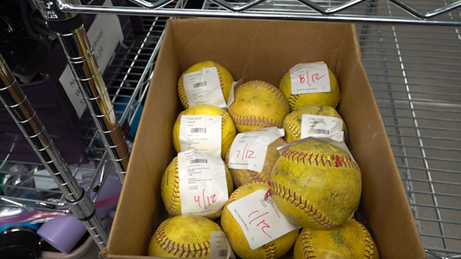 A box of softballs is left behind at the airport.