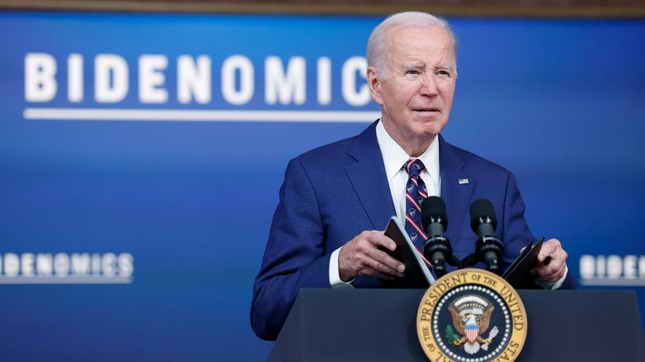 President Biden speaking with Bidenomics sign in background