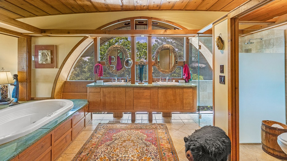 The ensuite bathroom boasts a bathtub, standing shower and double sinks.