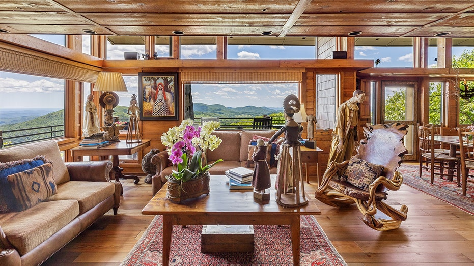 A sitting room adorned with Native American paintings and statues.