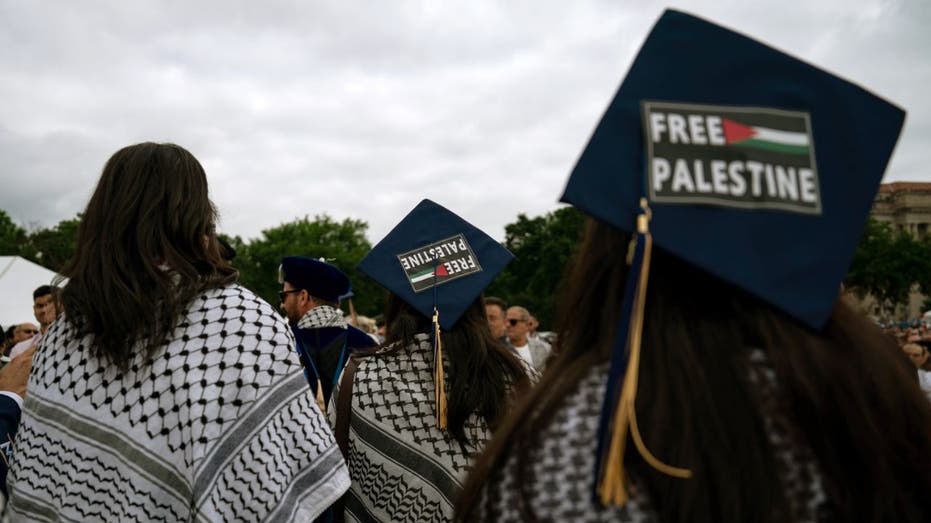 graduates with 'free palestine' signs on caps