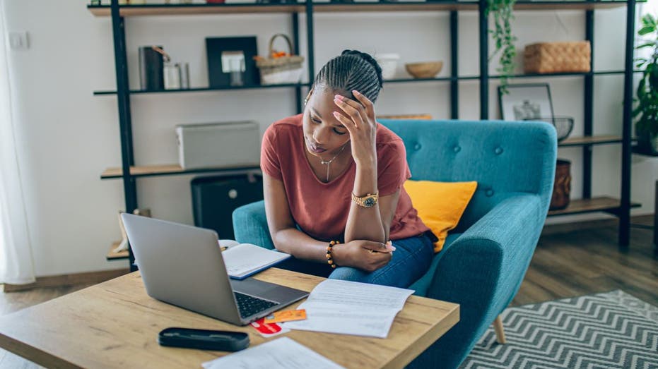 Worried woman looking at bills