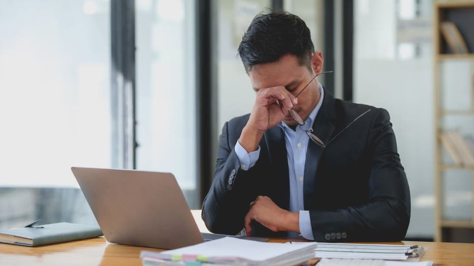 Stressed out man looking at budget