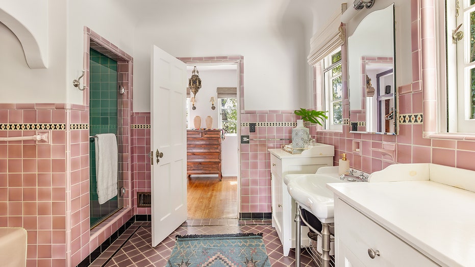 A bathroom with pink tiles.