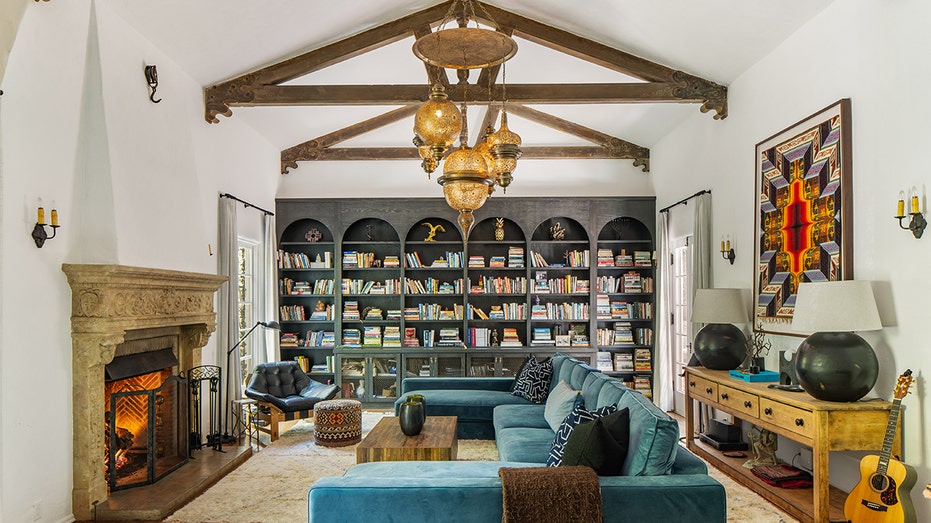 The living room features built-in bookshelves and a wood-burning fireplace.