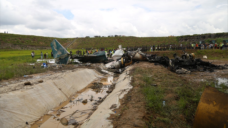 Plane parts scattered across a field