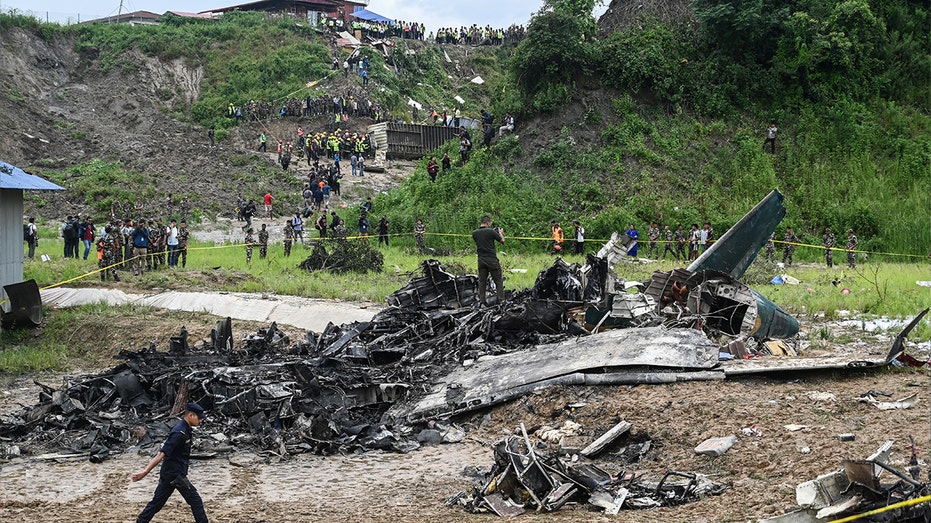 officials examine plane crash site in Nepal