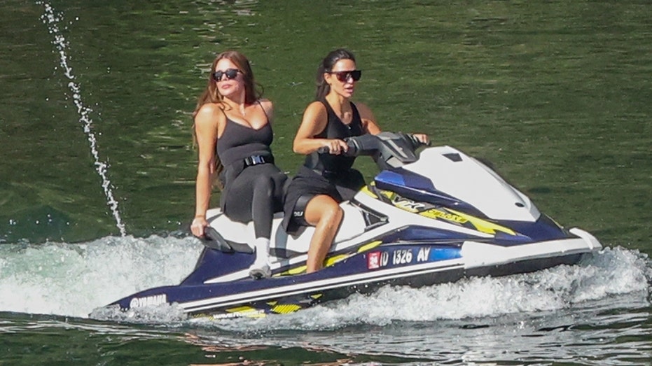 Khloé Kardashian and Kim Kardashian on a jet ski in Idaho