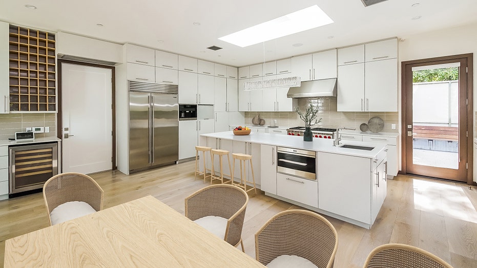 The chef's kitchen features a double oven, microwave and other desirable features.