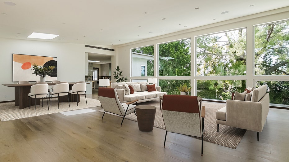 The expansive living room and dining room features floor to ceiling windows.