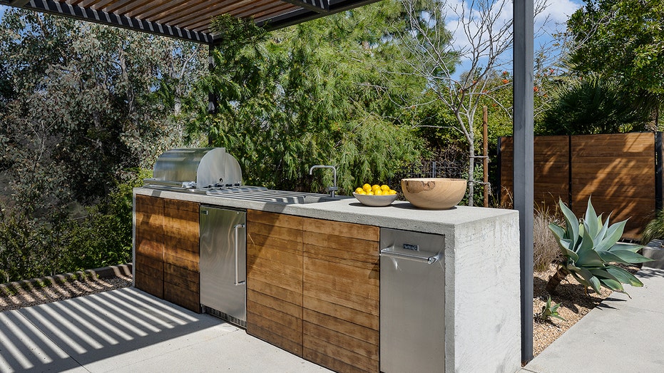 The backyard features an outdoor kitchen.