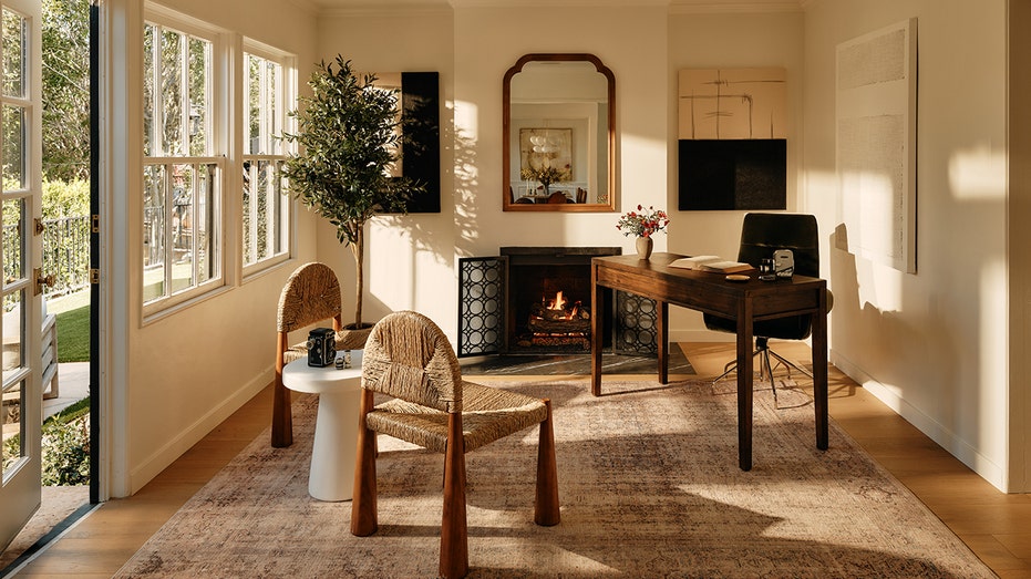 A room with a fireplace and a desk