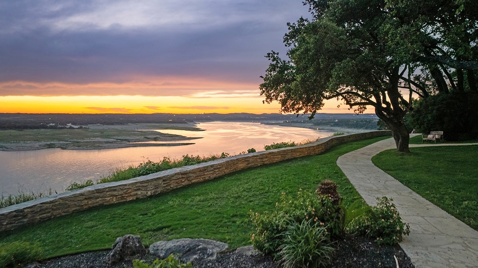 The outside of the home features a walking trail along the lake,