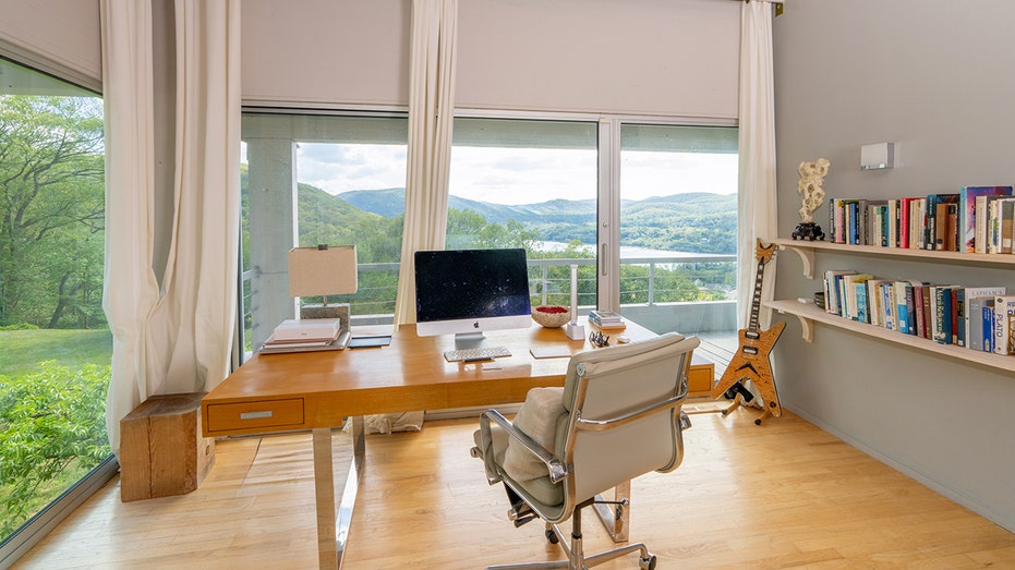 The office is nestled between two oversized windows, bringing in plenty of natural light.