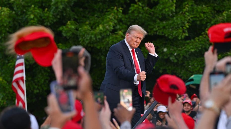 trump dancing on stage at a rally