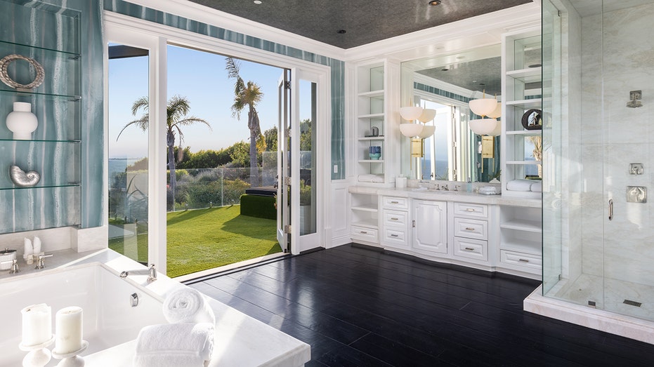 An ensuite bathroom with a jacuzzi tub and a standing shower.