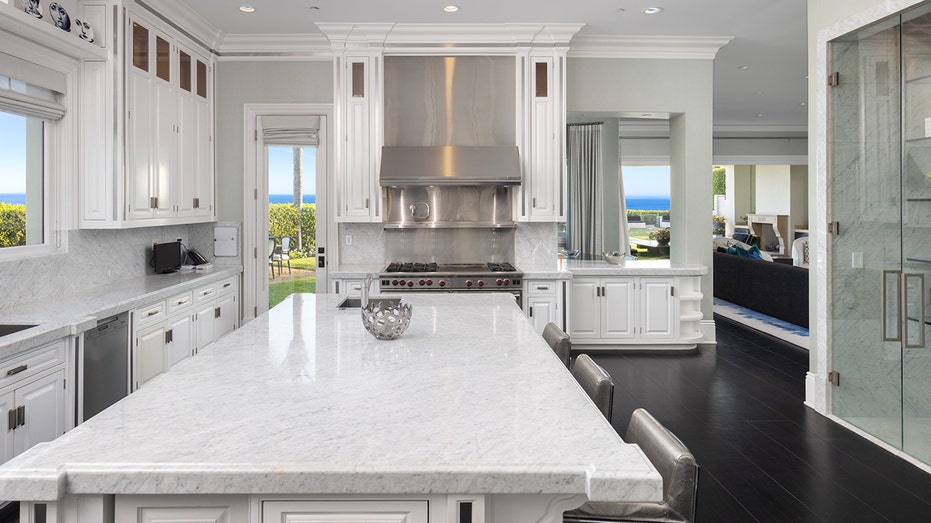 The all-white kitchen features top of the line appliances and a "frantry."