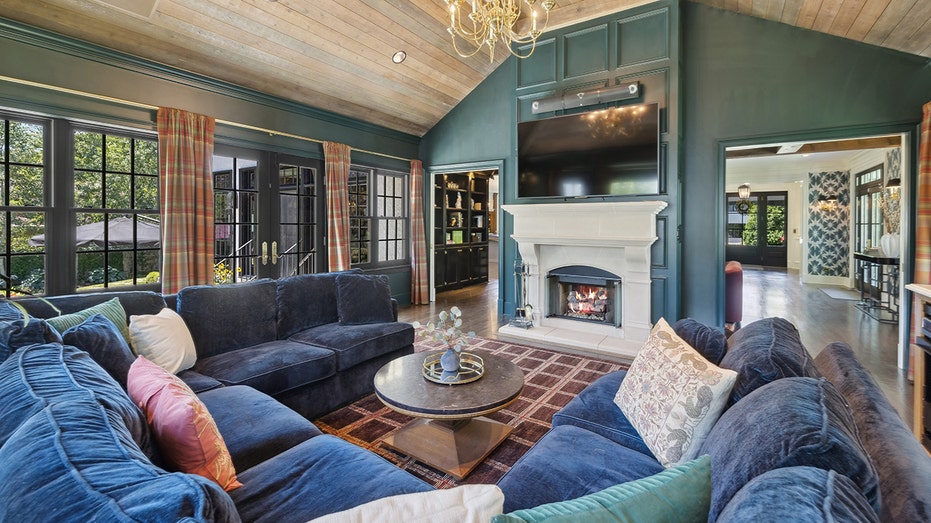 The cozy family room is found on the other side of the double-sided fireplace.